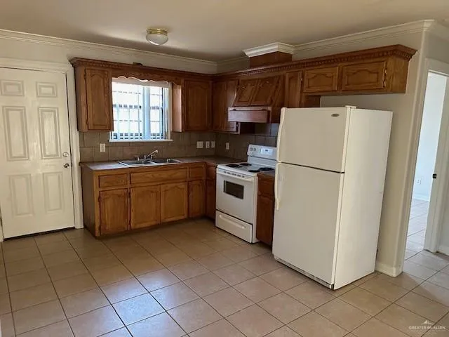 a kitchen with cabinets and white stainless steel appliances