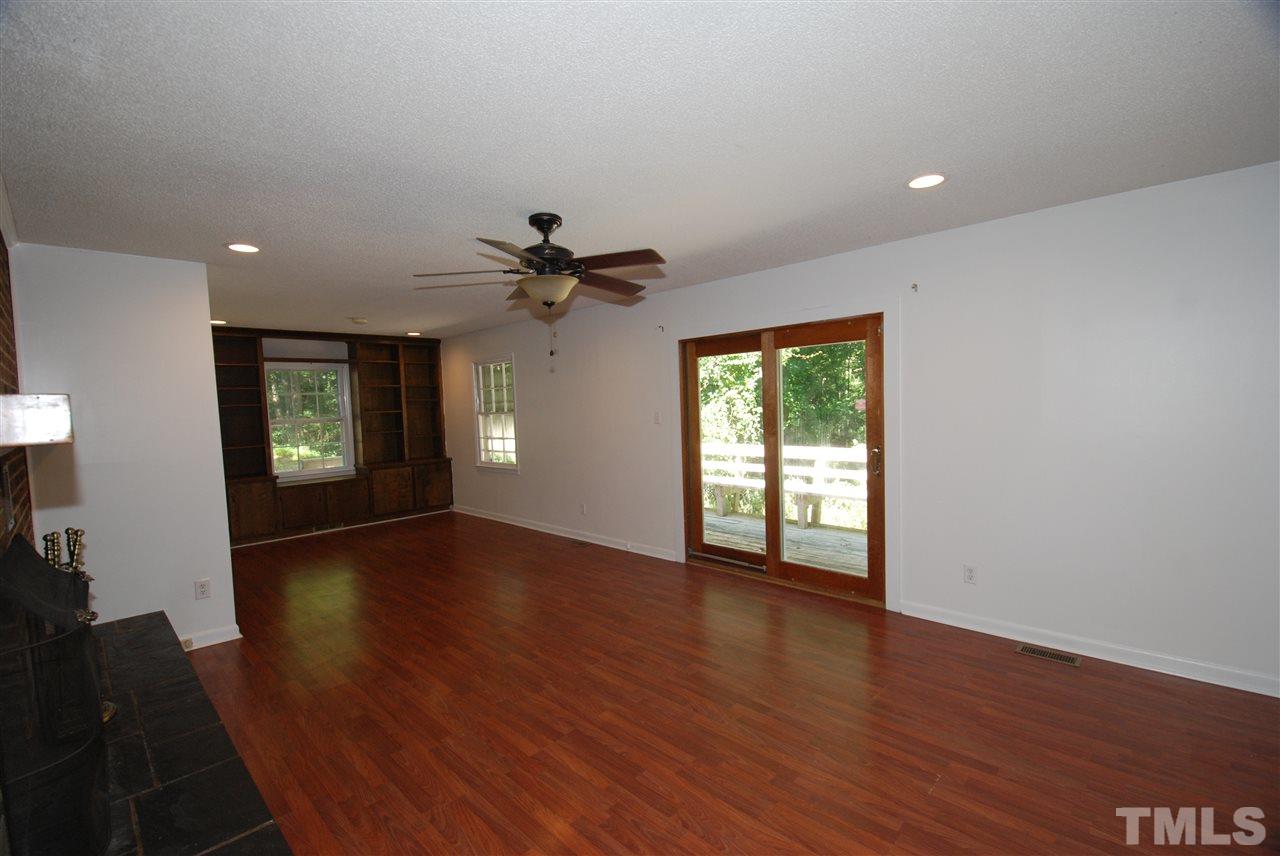 6908 Lake Wheeler Road Raleigh, NC 27603 - Photo 11 of 25 a view of an empty room with wooden floor and a window