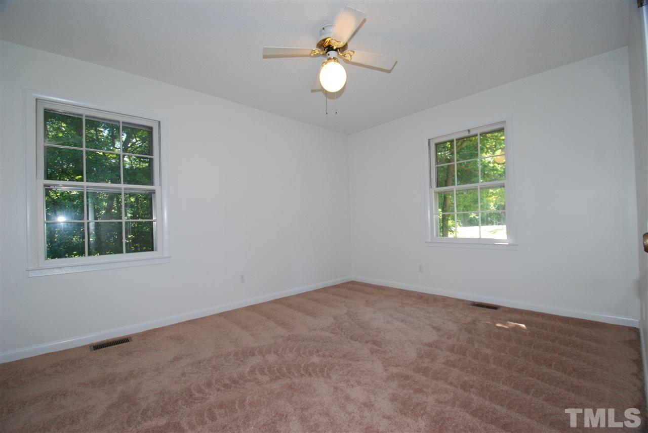 6908 Lake Wheeler Road Raleigh, NC 27603 - Photo 17 of 25 an empty room with a window and a fan