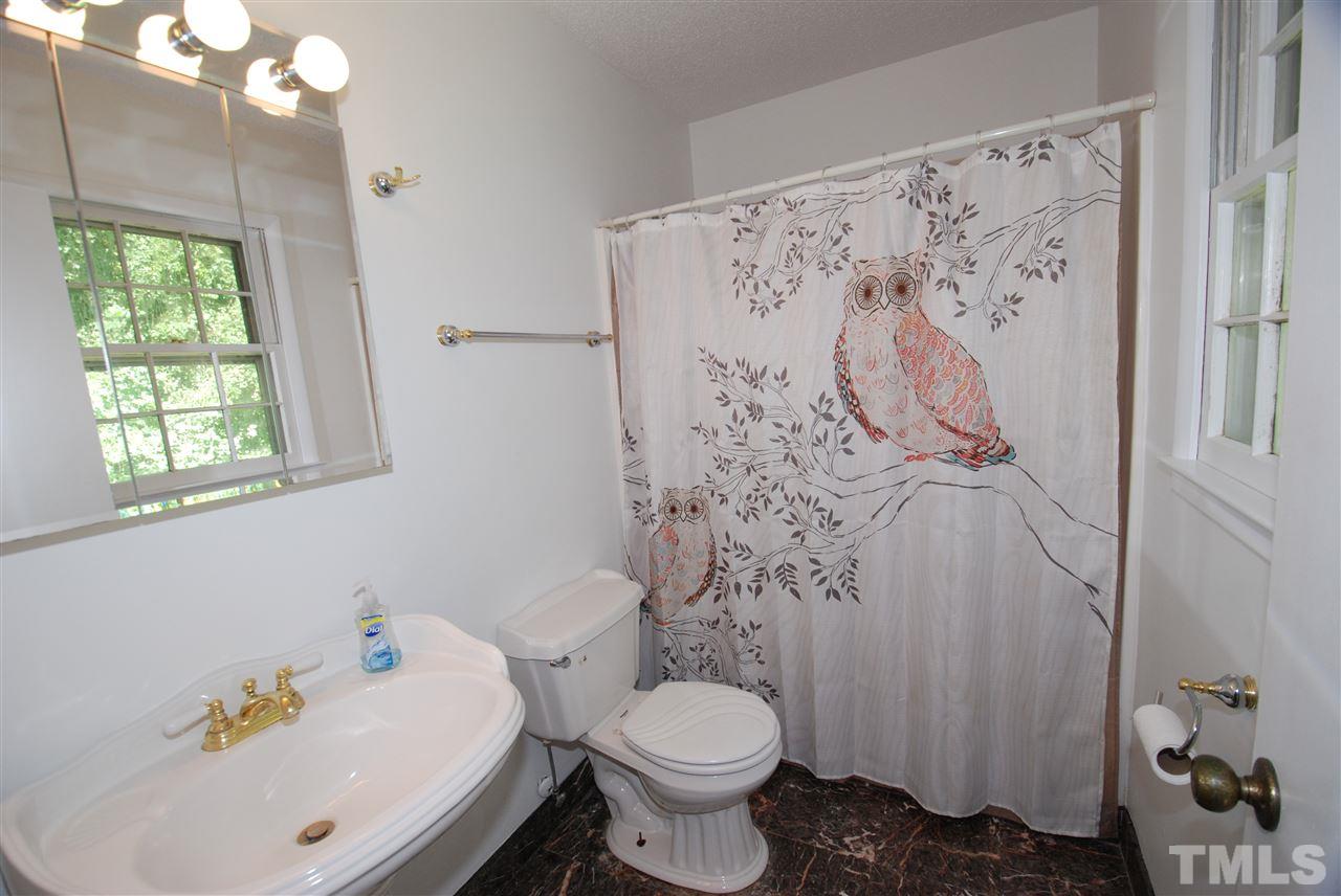6908 Lake Wheeler Road Raleigh, NC 27603 - Photo 19 of 25 a white toilet sitting next to a bathroom sink
