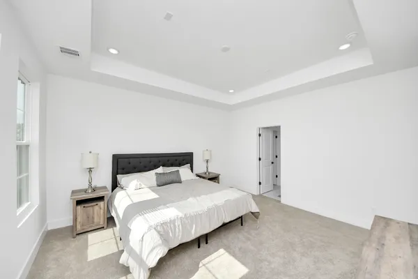 a bedroom with a bed and a night stand