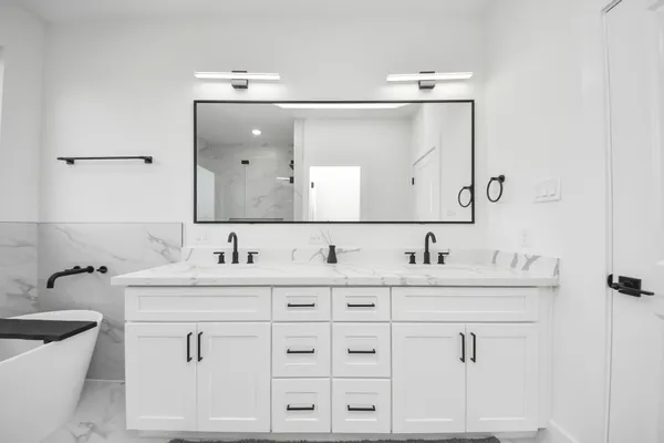a bathroom with a double vanity sink and mirror