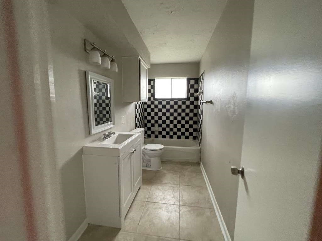 2310 Heather Street Highlands, TX 77562 - Photo 11 of 16 a bathroom with a sink toilet and shower
