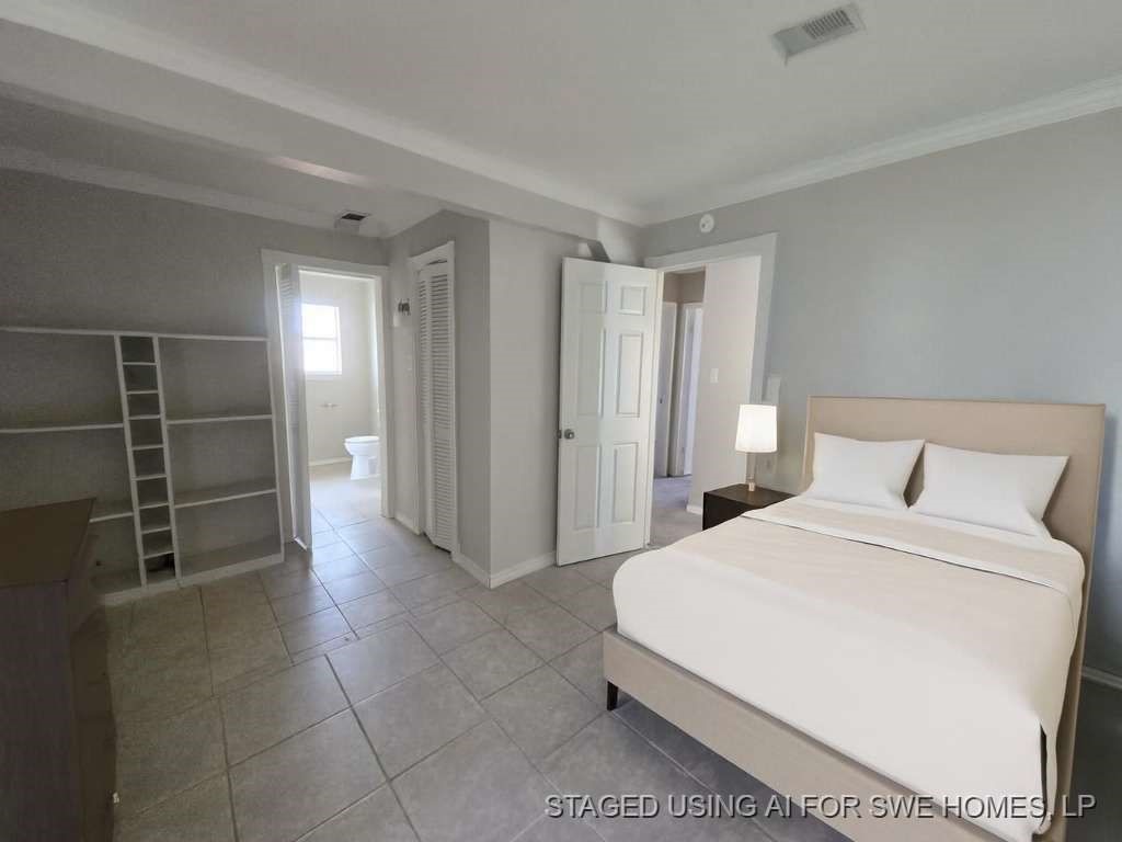 2310 Heather Street Highlands, TX 77562 - Photo 10 of 16 a spacious bedroom with a bed and a cabinets