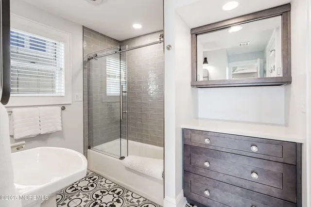 a bathroom with a sink toilet and a mirror