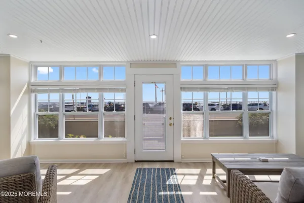 a living room with stainless steel appliances kitchen island granite countertop a stove and a refrigerator