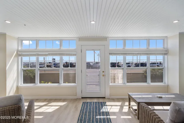 a living room with stainless steel appliances kitchen island granite countertop a stove and a refrigerator