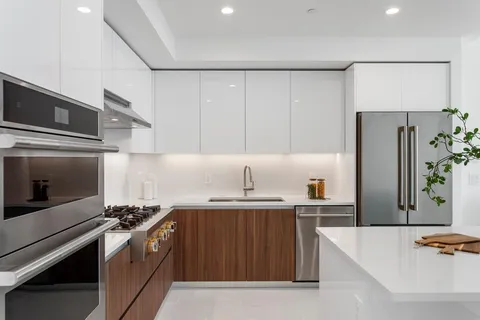 a kitchen with stainless steel appliances a sink stove and refrigerator