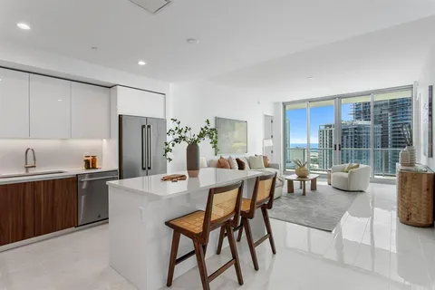 a dining hall with stainless steel appliances a table and chairs