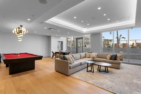 a room with pool table and windows