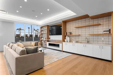 a dining room with furniture and a floor to ceiling window