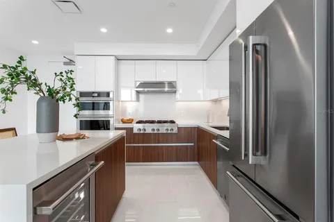 a kitchen with stainless steel appliances a sink stove and refrigerator