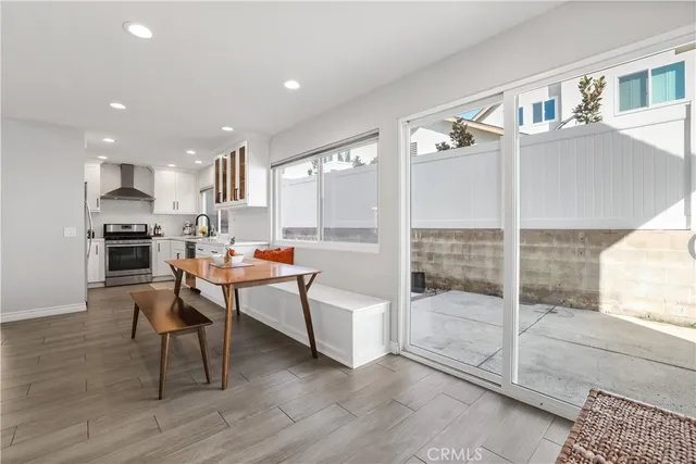 a kitchen with stainless steel appliances granite countertop a refrigerator and a stove top oven with white countertops
