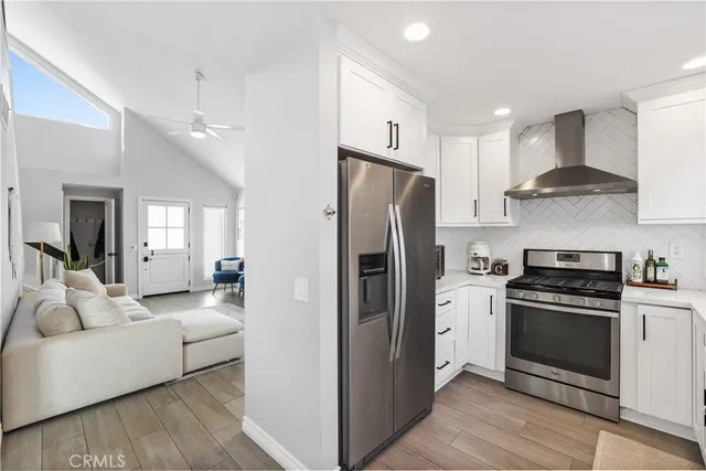 a kitchen with stainless steel appliances granite countertop a refrigerator and a sink