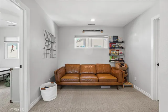 a bedroom with a bed a couch and a large window