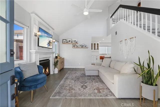 a living room with furniture a fireplace and a large window