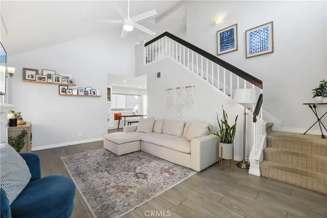a living room with furniture and stairs