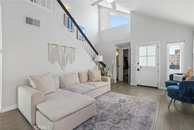 a living room with furniture a fireplace and a large window
