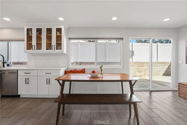 a living room with furniture a rug and kitchen view