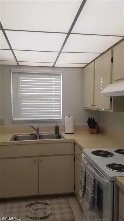 1000 Manatee Road, Unit A105 Naples, FL 34114 - Photo 11 of 22 a kitchen with a sink stove and cabinets