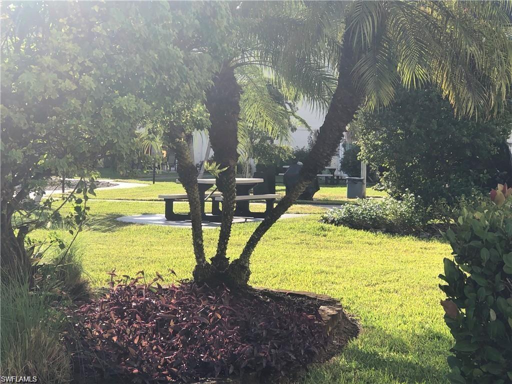 1000 Manatee Road, Unit A105 Naples, FL 34114 - Photo 16 of 22 a view of a swimming pool with an outdoor space and seating area