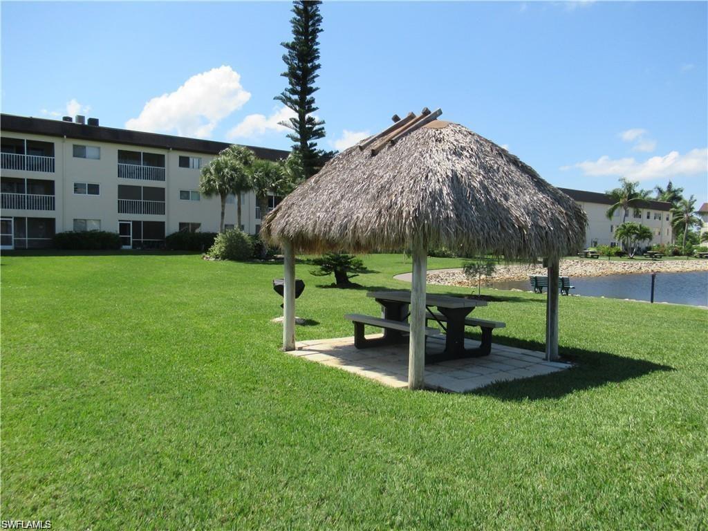 1000 Manatee Road, Unit A105 Naples, FL 34114 - Photo 21 of 22 a view of a bench in a garden