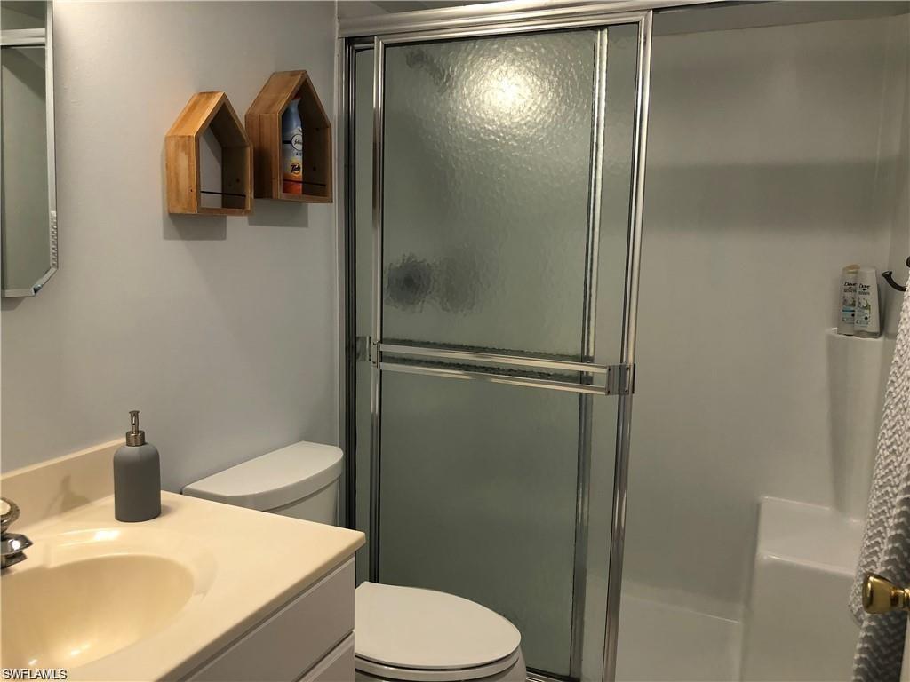1000 Manatee Road, Unit A105 Naples, FL 34114 - Photo 6 of 22 a bathroom with a sink toilet and shower