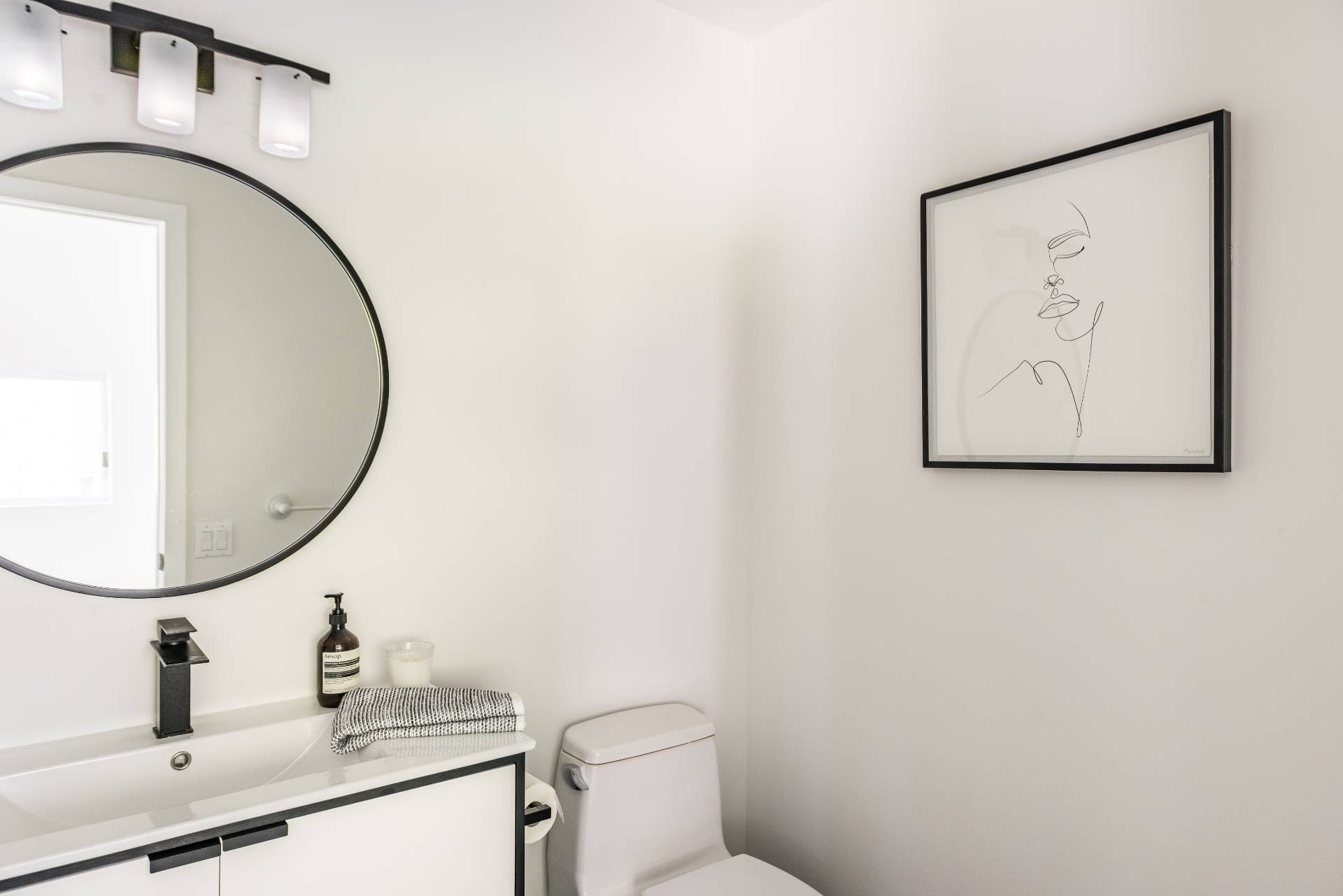52 Bull Path East Hampton, NY 11937 - Photo 16 of 24 a bathroom with a toilet a sink and mirror