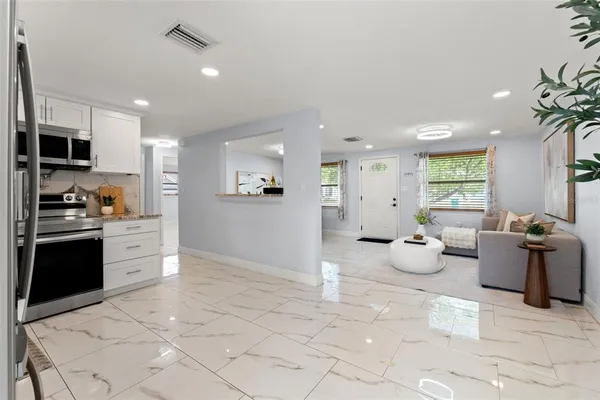 a kitchen with stainless steel appliances a refrigerator sink and microwave