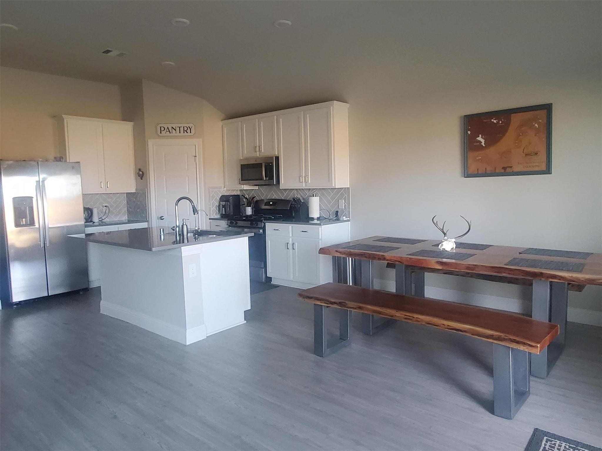 1208 Mare Stable Court Alvin, TX 77511 - Photo 11 of 19 a kitchen with a sink cabinets and wooden floor
