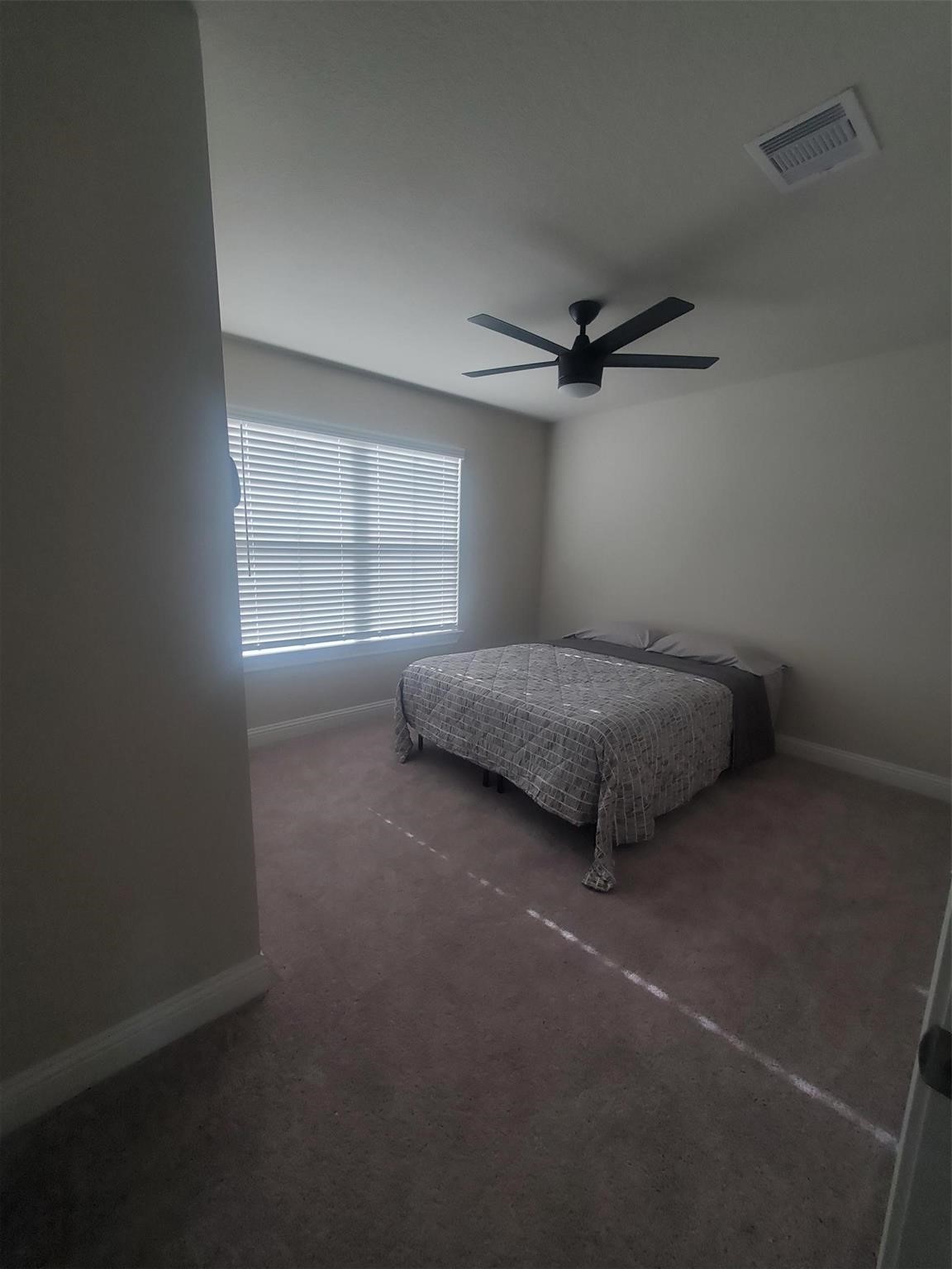1208 Mare Stable Court Alvin, TX 77511 - Photo 15 of 19 a bedroom with a bed and a window