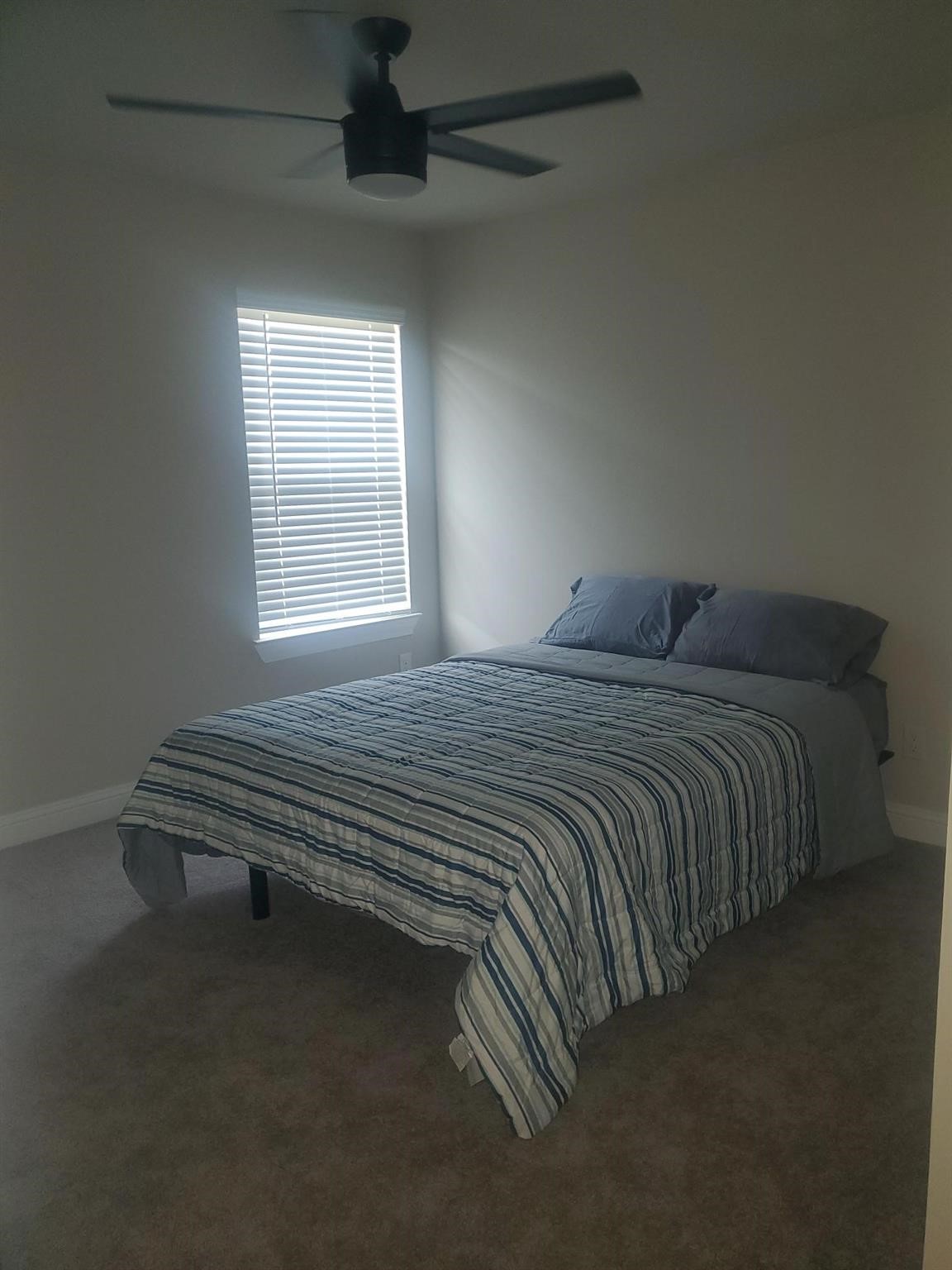 1208 Mare Stable Court Alvin, TX 77511 - Photo 16 of 19 a bed sitting in a bedroom next to a window