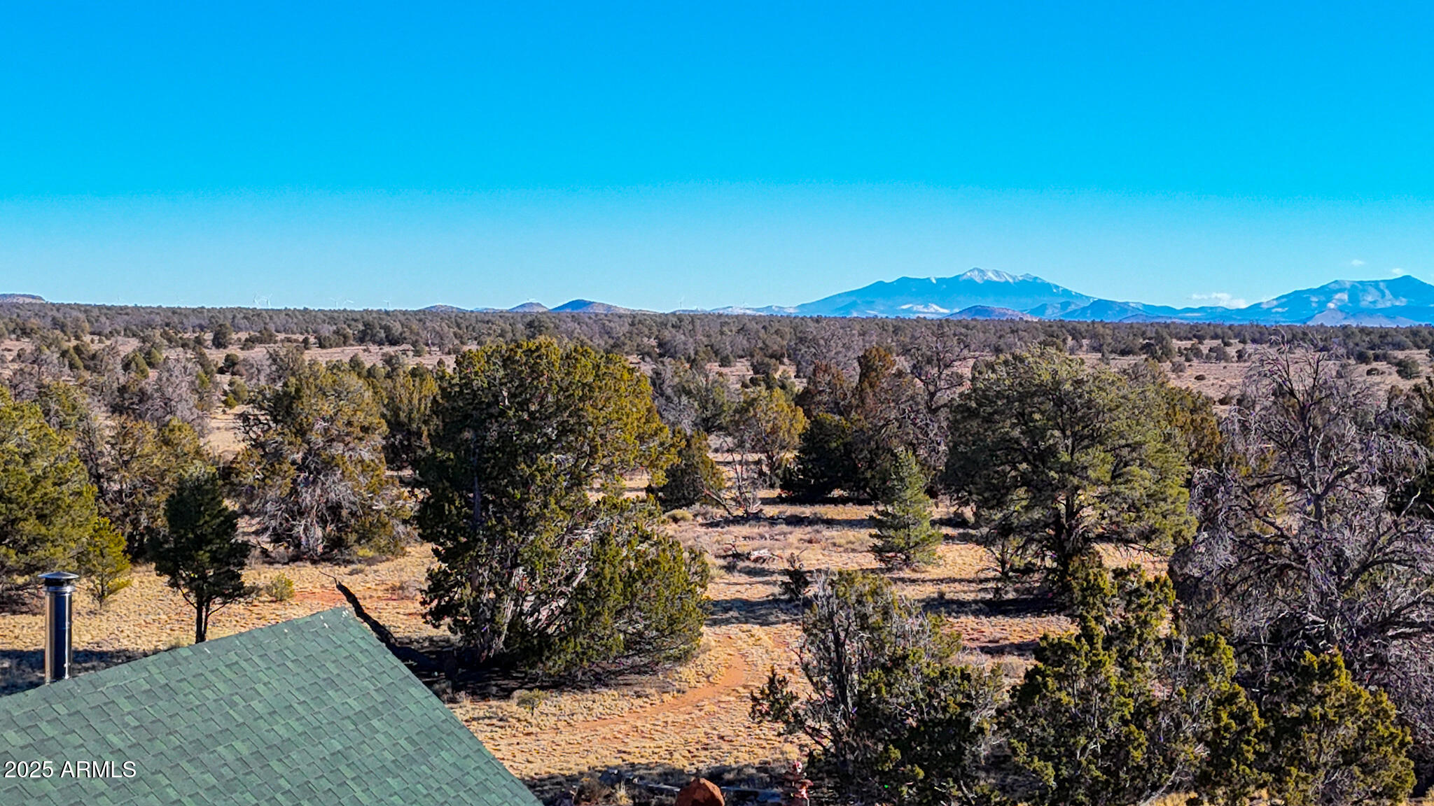 5823 North Cattle Guard Road Williams, AZ 86046 - Photo 2 of 37 a view of a house with a yard and mountain in the background