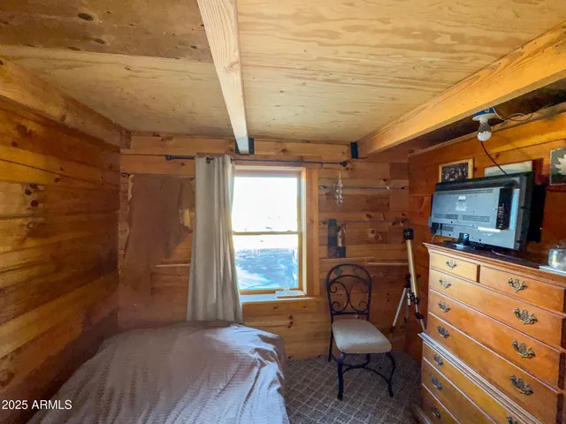 a bedroom with furniture and a window