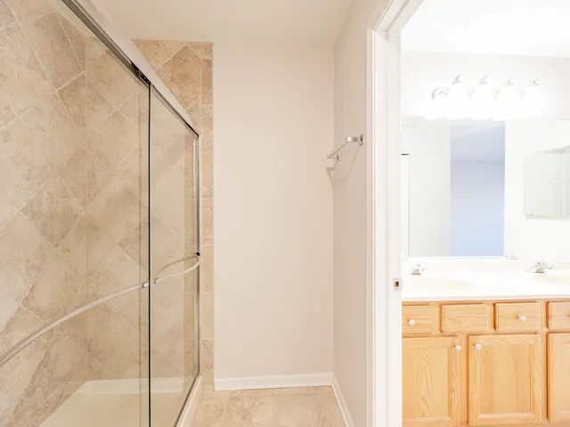 a bathroom with a shower and a sink