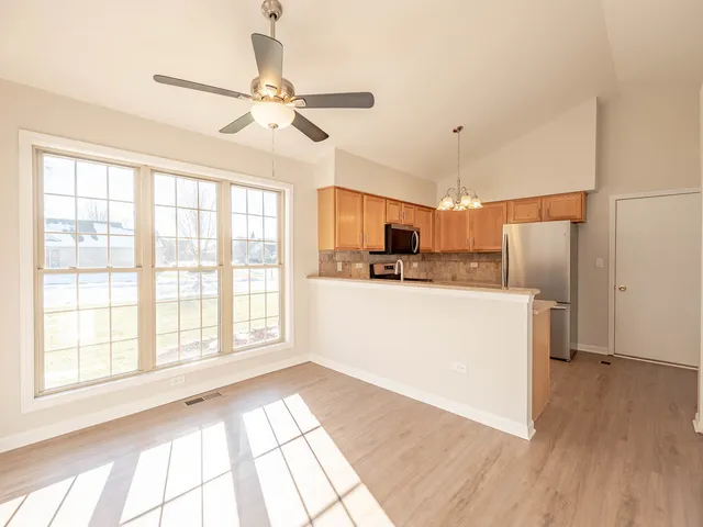 a view of kitchen with stainless steel appliances cabinets