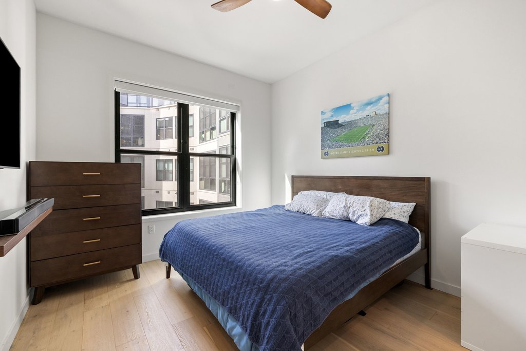 800 Embassy Drive, Unit 413 Austin, TX 78702 - Photo 9 of 27 Bedroom featuring light wood finished floors and ceiling fan