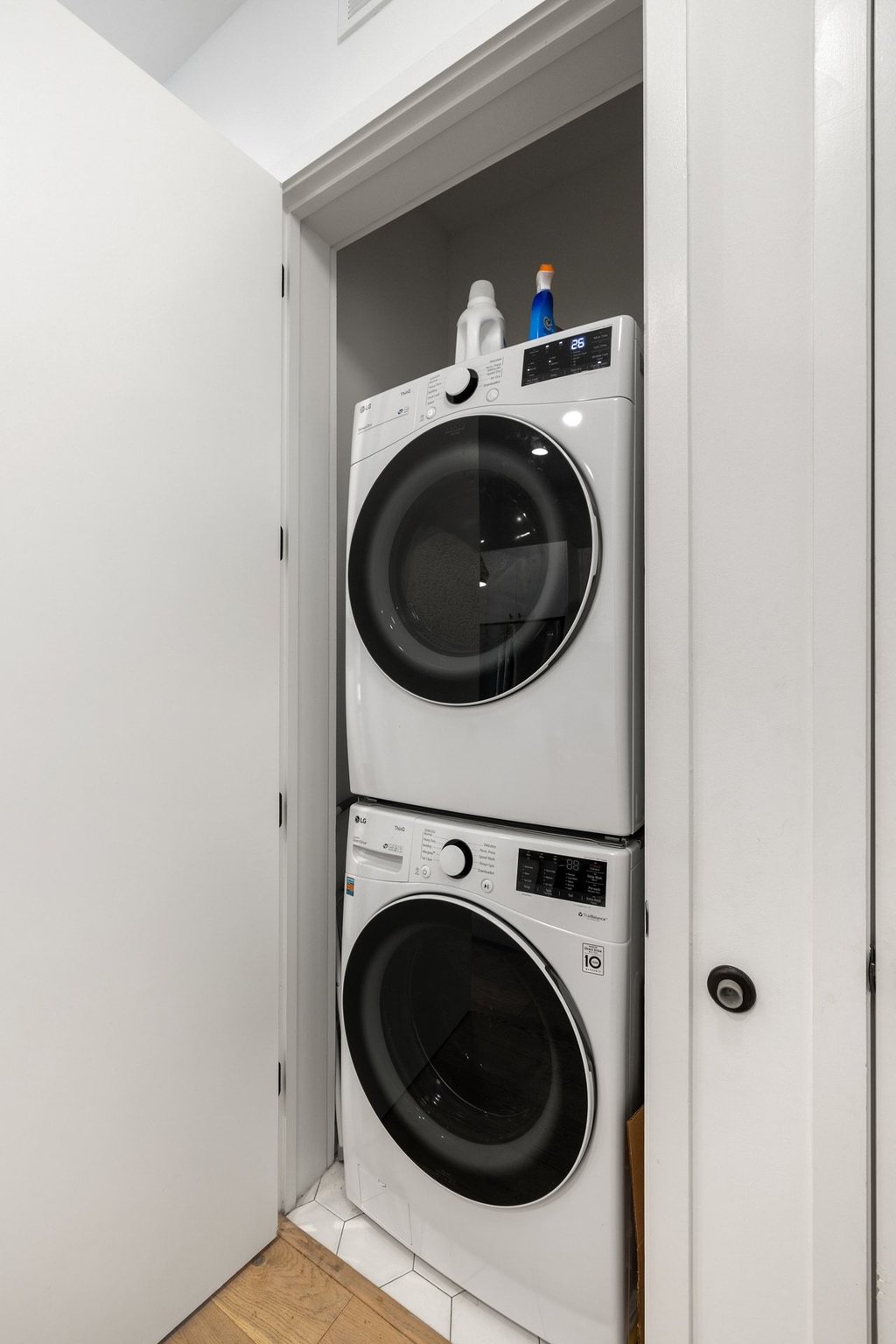 800 Embassy Drive, Unit 413 Austin, TX 78702 - Photo 14 of 27 Laundry area with stacked washer and dryer and light wood-style floors
