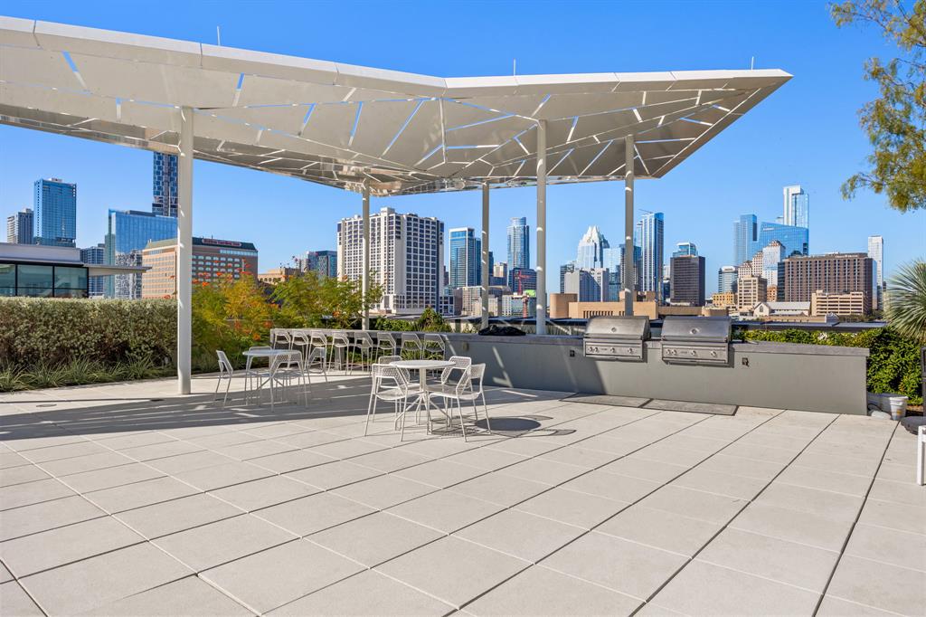 800 Embassy Drive, Unit 413 Austin, TX 78702 - Photo 15 of 27 View of patio / terrace with a skyline view and a grill
