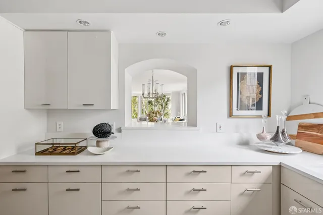 a kitchen with a oven a white cabinets and a window