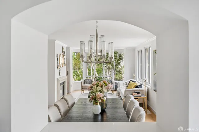 a living room with furniture and a chandelier