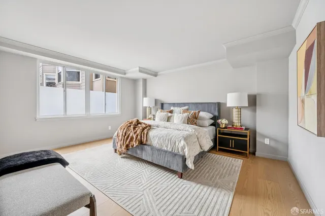 a bedroom with a bed and wooden floor