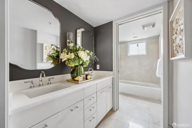 a bathroom with a sink a vanity and a bathtub