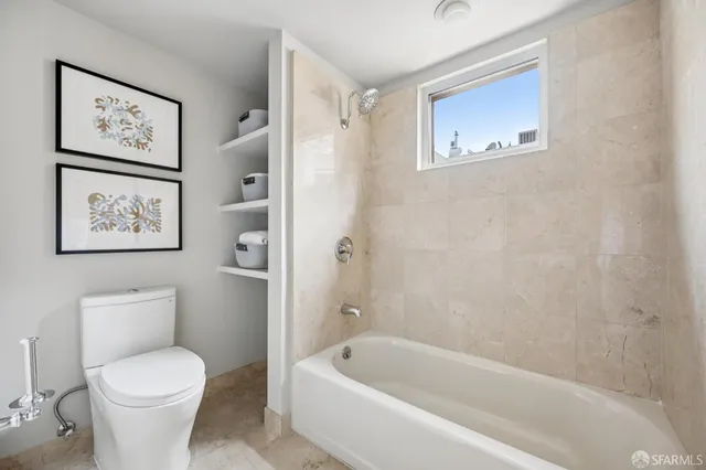 a bathroom with a toilet and a bath tub