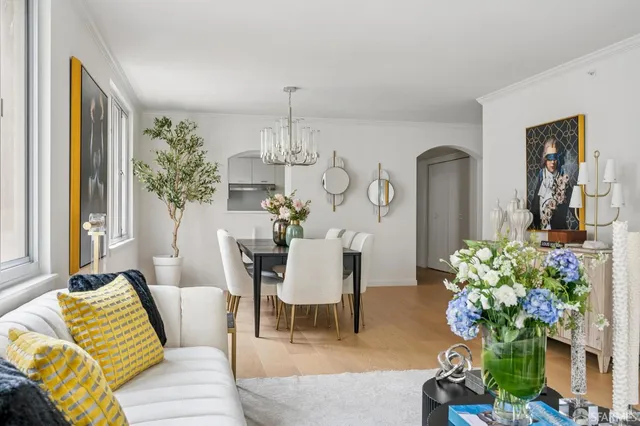 a dining room with furniture and a chandelier
