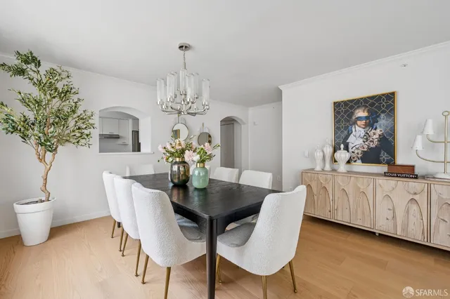 a view of a dining room with furniture and chandelier