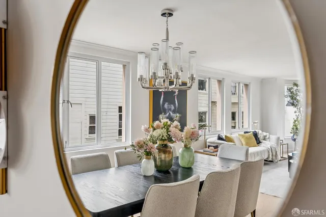 a dining room with furniture window and wooden floor