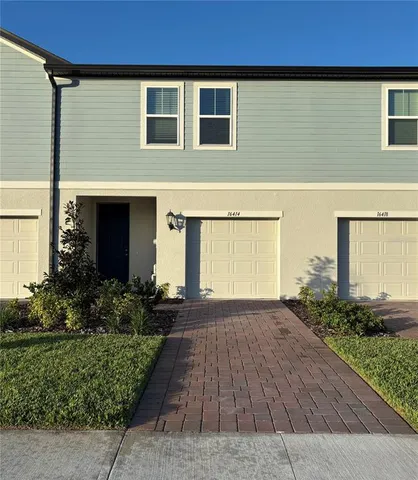 a front view of house and yard with green space
