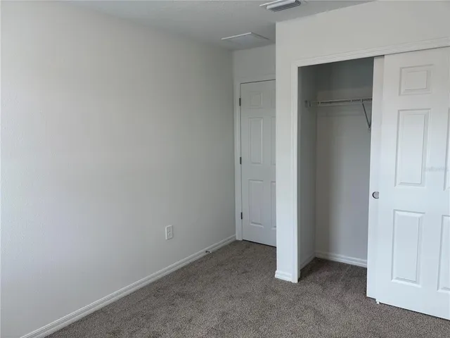 a bathroom with a granite countertop toilet and a sink