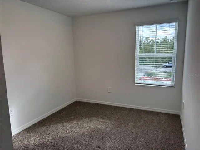 a view of a house with a yard and plants